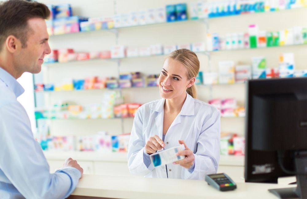 pharmacist serving patient